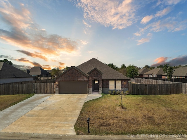 view of front of house with a garage and a yard