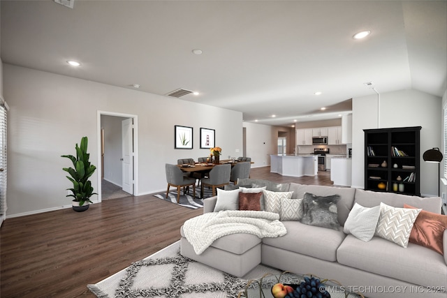 living room featuring lofted ceiling and dark hardwood / wood-style floors