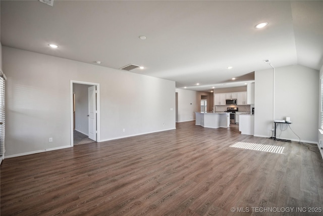 unfurnished living room with lofted ceiling and dark wood-type flooring