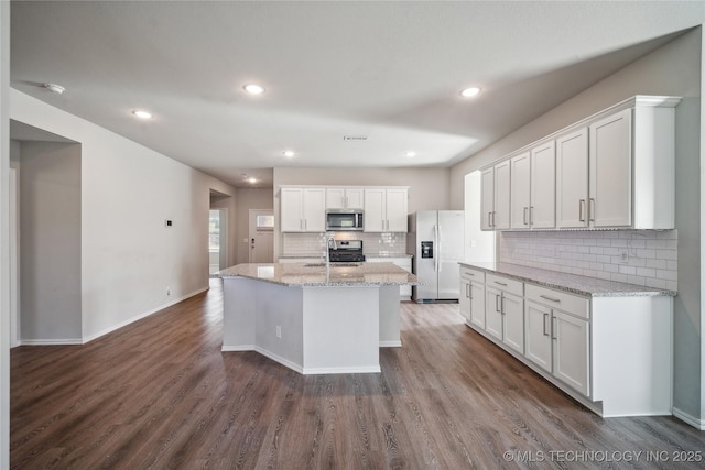 kitchen featuring stainless steel appliances, an island with sink, and white cabinets