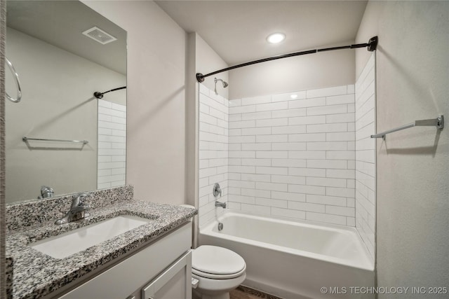 full bathroom featuring vanity, tiled shower / bath combo, and toilet