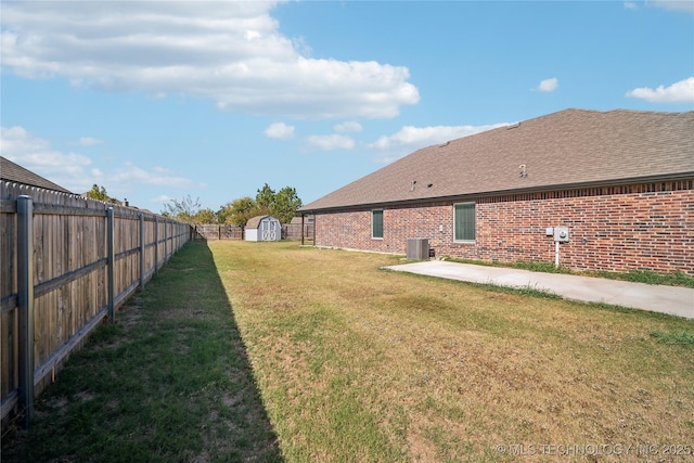 view of yard featuring a storage shed, central AC, and a patio area