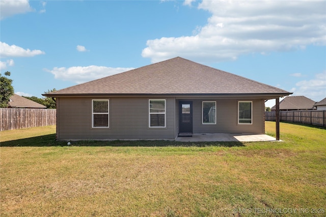 back of house featuring a yard and a patio