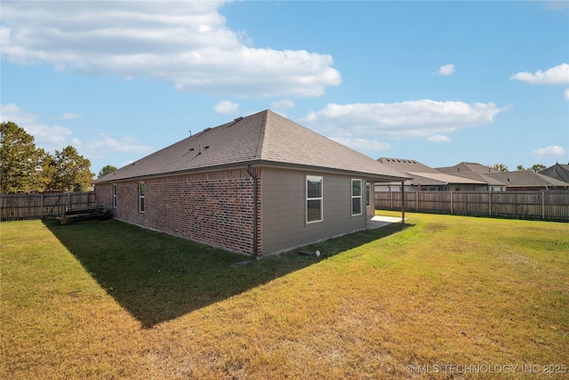 back of house with a yard