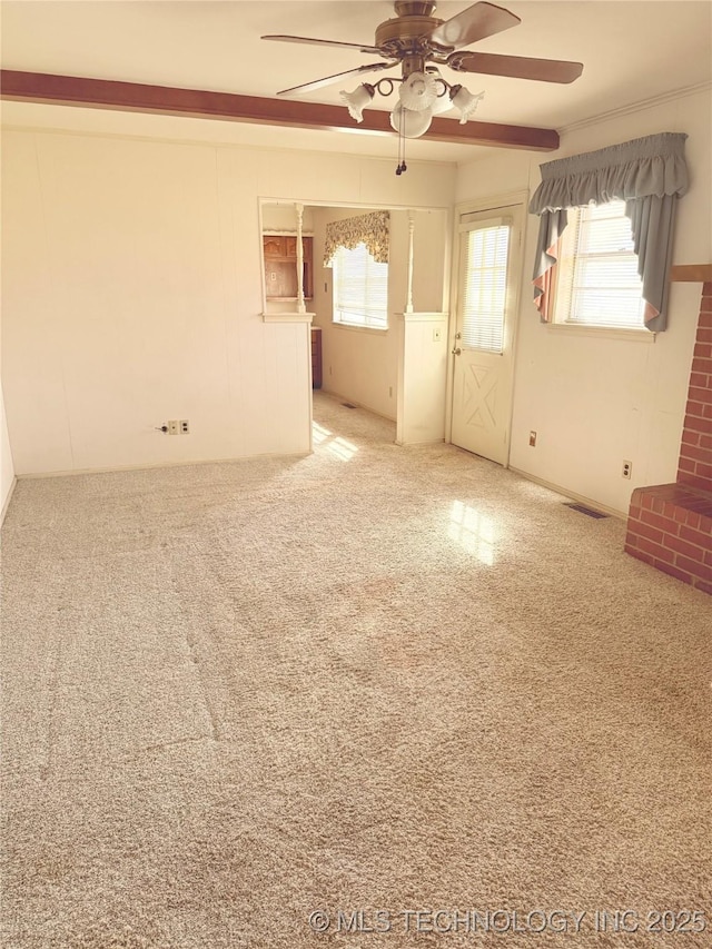 carpeted empty room with visible vents and ceiling fan