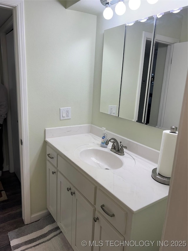 bathroom featuring vanity and hardwood / wood-style floors