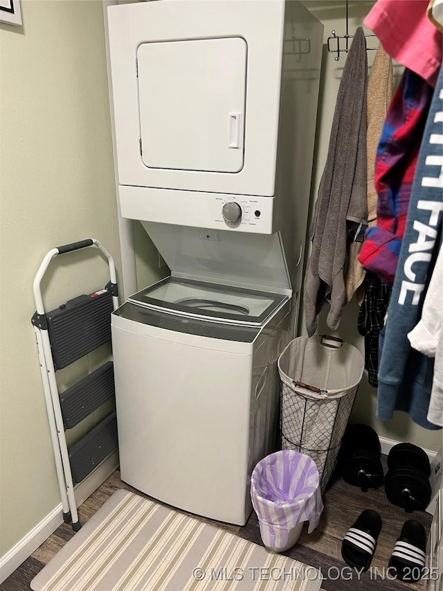 laundry room with stacked washer / drying machine and light hardwood / wood-style floors