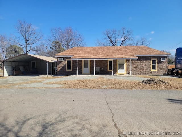 ranch-style house featuring a carport and a porch