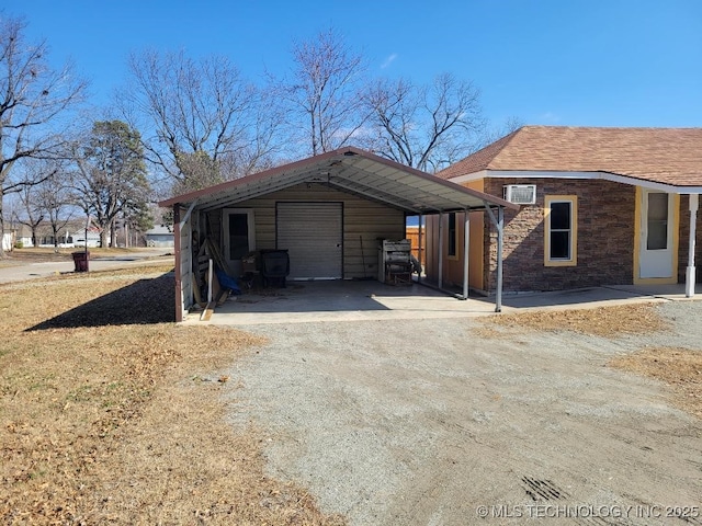 view of home's exterior with a garage, an outdoor structure, and a carport