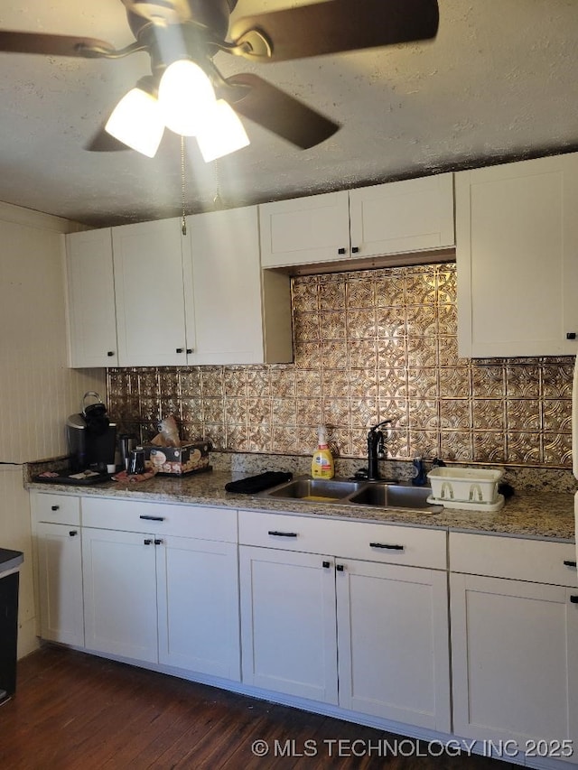 kitchen with white cabinetry, sink, and decorative backsplash