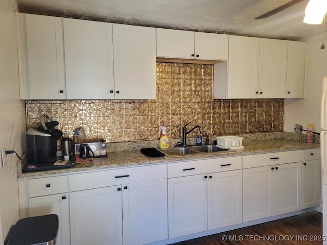 kitchen with white cabinetry, sink, and tasteful backsplash