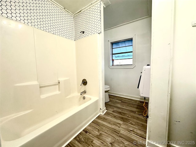 bathroom featuring wood-type flooring, toilet, and  shower combination