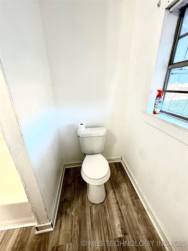 bathroom featuring hardwood / wood-style floors and toilet