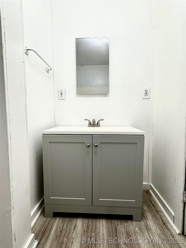 bathroom with vanity and wood-type flooring