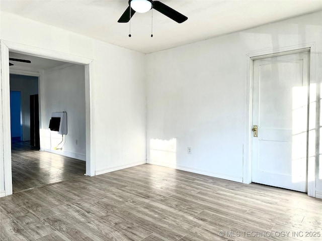 spare room with hardwood / wood-style flooring and ceiling fan