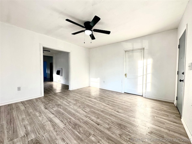 empty room featuring ceiling fan and light hardwood / wood-style flooring