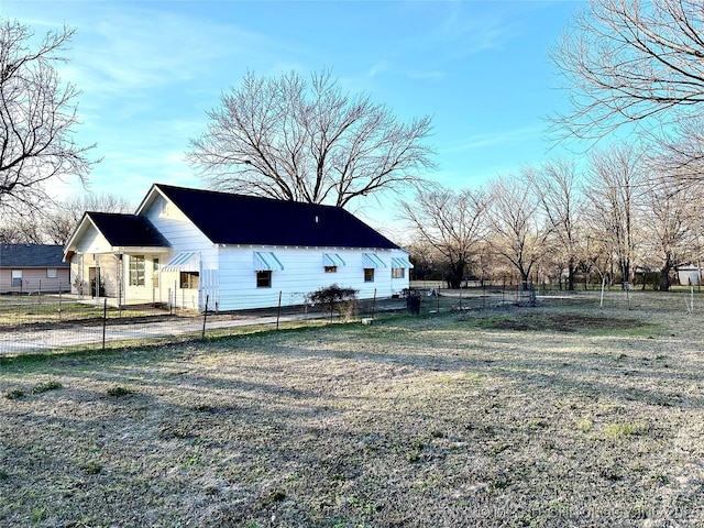 view of side of home featuring a lawn