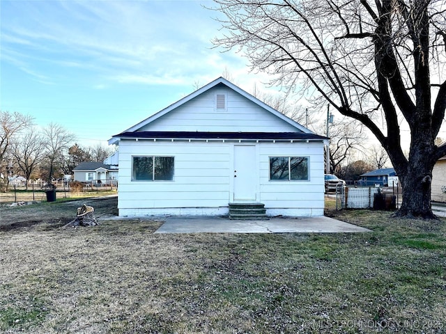 rear view of property with a lawn and a patio area