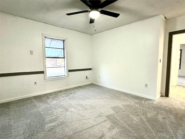 carpeted empty room featuring a textured ceiling and ceiling fan