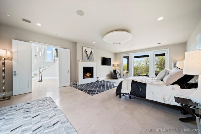 bedroom with light tile patterned floors, recessed lighting, visible vents, access to outside, and a lit fireplace