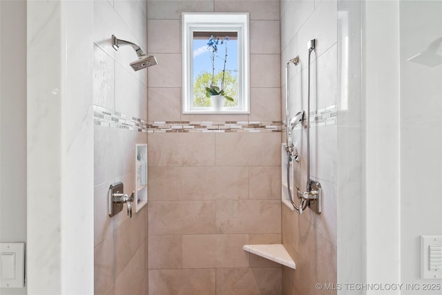 bathroom featuring a tile shower