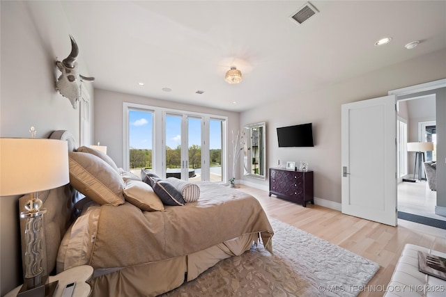 bedroom featuring light wood finished floors, baseboards, access to outside, french doors, and recessed lighting