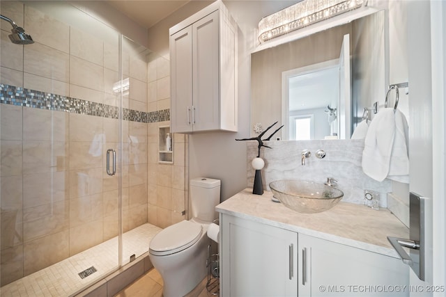 full bath with toilet, a stall shower, and vanity