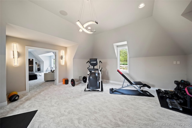 workout area with lofted ceiling, light carpet, and baseboards