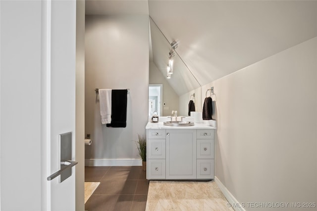 bathroom featuring tile patterned flooring, baseboards, and vanity