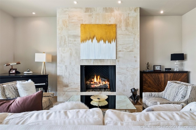 living room featuring recessed lighting and a fireplace