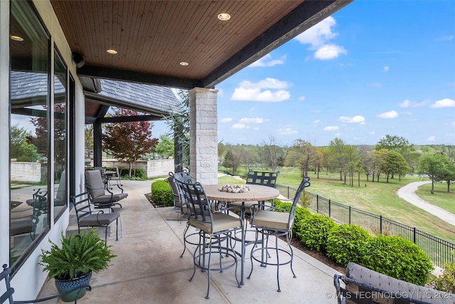 view of patio with fence and outdoor dining space