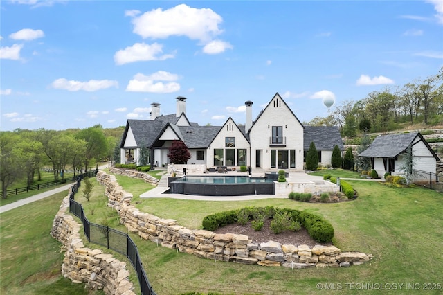 view of home's community with a patio, an outdoor structure, fence, a yard, and a swimming pool