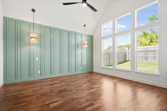 unfurnished room featuring high vaulted ceiling, dark hardwood / wood-style floors, and ceiling fan