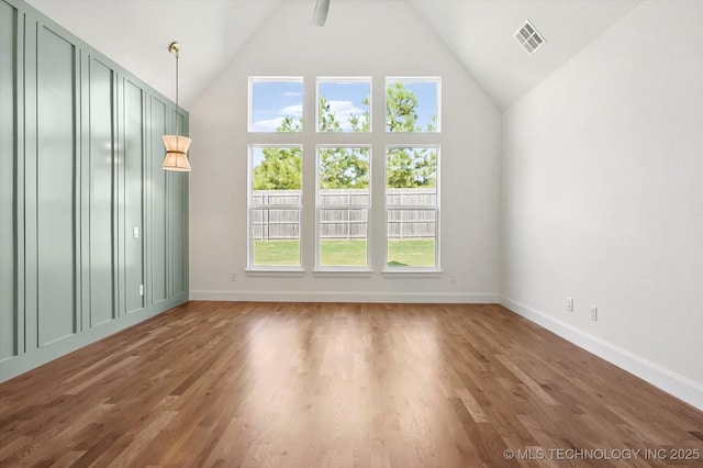 unfurnished room with wood-type flooring, high vaulted ceiling, and ceiling fan