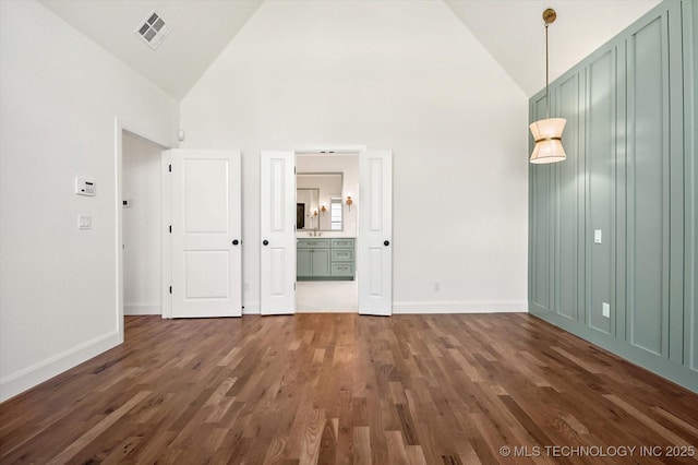 empty room featuring dark hardwood / wood-style floors and high vaulted ceiling