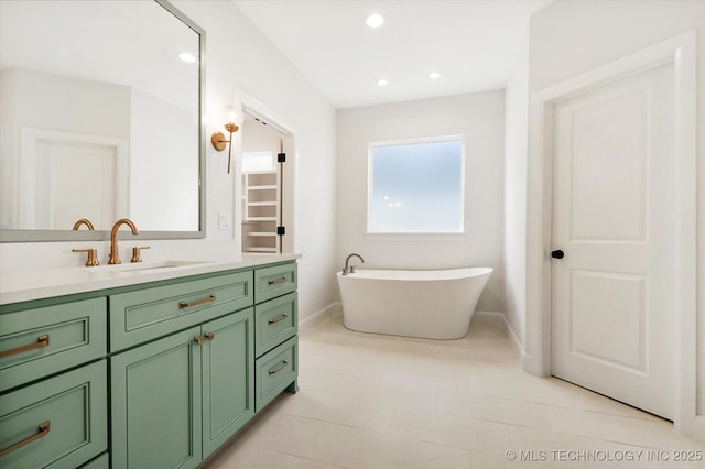 bathroom with vanity and a bath