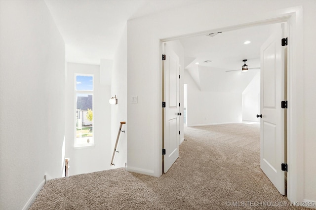 hallway featuring light carpet