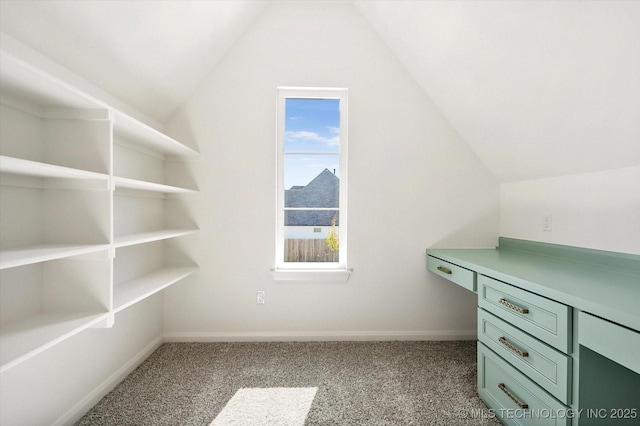 walk in closet featuring light carpet and lofted ceiling