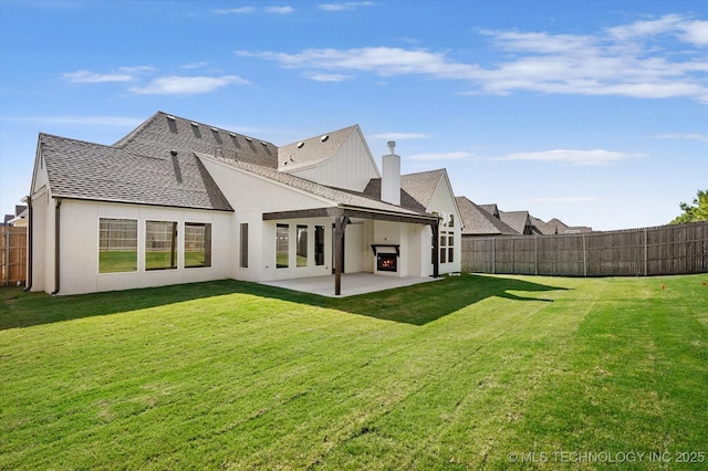 rear view of property featuring a lawn and a patio