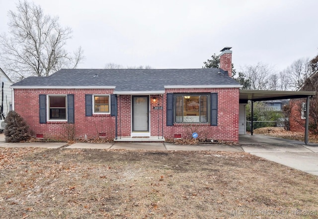 ranch-style home with roof with shingles, brick siding, crawl space, and a chimney