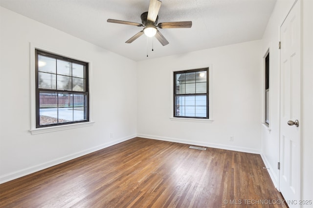 3006 E 21st St, Tulsa, OK 74114 - unfurnished bedroom with wood finished floors and ceiling fan
