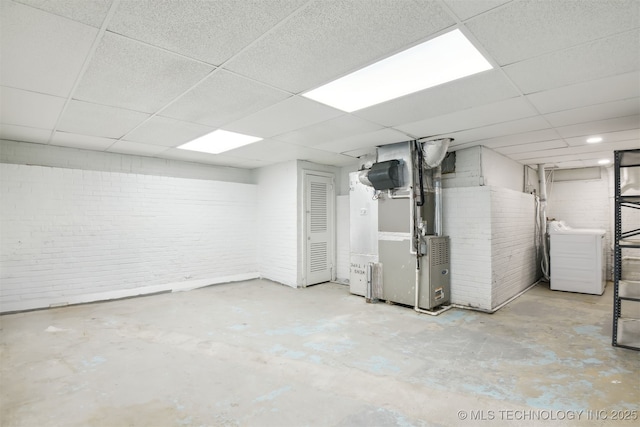 3006 E 21st St, Tulsa, OK 74114 - below grade area with washer / dryer, a paneled ceiling, brick wall, and heating unit