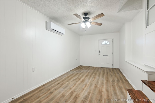 3006 E 21st St, Tulsa, OK 74114 - entrance foyer with a wall mounted air conditioner, wood finished floors, a textured ceiling, a ceiling fan, and crown molding