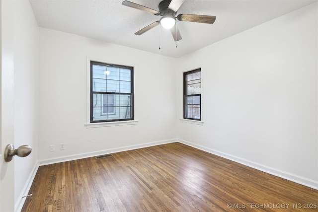 3006 E 21st St, Tulsa, OK 74114 - unfurnished room featuring healthy amount of natural light, wood finished floors, and ceiling fan