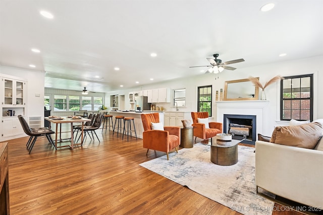3006 E 21st St, Tulsa, OK 74114 - living area featuring recessed lighting, ceiling fan, a fireplace with flush hearth, and light wood finished floors