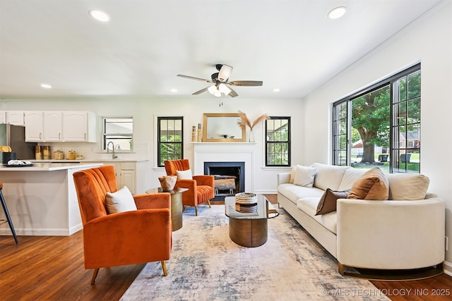 3006 E 21st St, Tulsa, OK 74114 - living room featuring recessed lighting, wood finished floors, a fireplace with flush hearth, and a ceiling fan