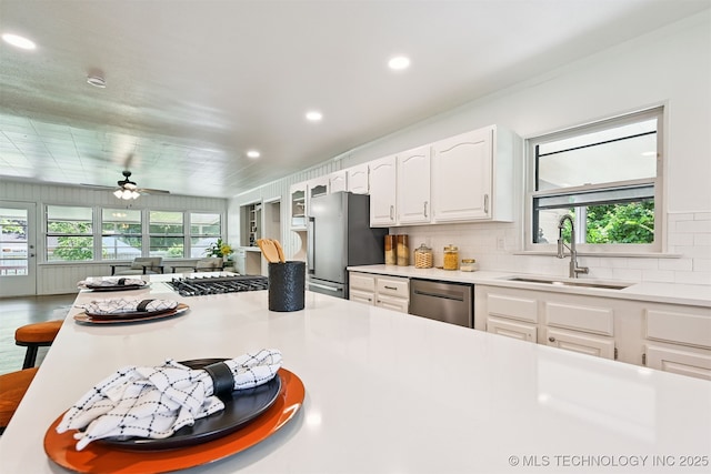 3006 E 21st St, Tulsa, OK 74114 - kitchen featuring stainless steel appliances, recessed lighting, white cabinetry, light countertops, and tasteful backsplash