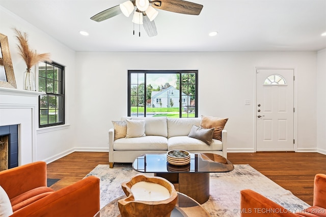 3006 E 21st St, Tulsa, OK 74114 - living area with plenty of natural light, wood finished floors, a ceiling fan, a tile fireplace, and recessed lighting
