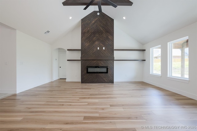 2044 E 129th Pl S, Jenks, OK 74037 - unfurnished living room featuring a ceiling fan, high vaulted ceiling, arched walkways, light wood-style floors, and a large fireplace