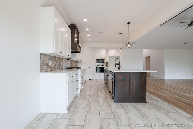 2044 E 129th Pl S, Jenks, OK 74037 - kitchen with light countertops, stainless steel appliances, white cabinets, open floor plan, and recessed lighting
